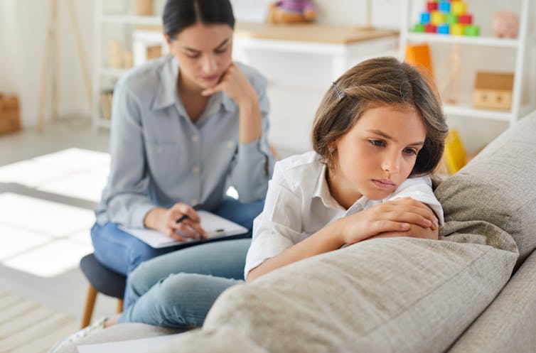 girl in clinical setting turning away from therapist