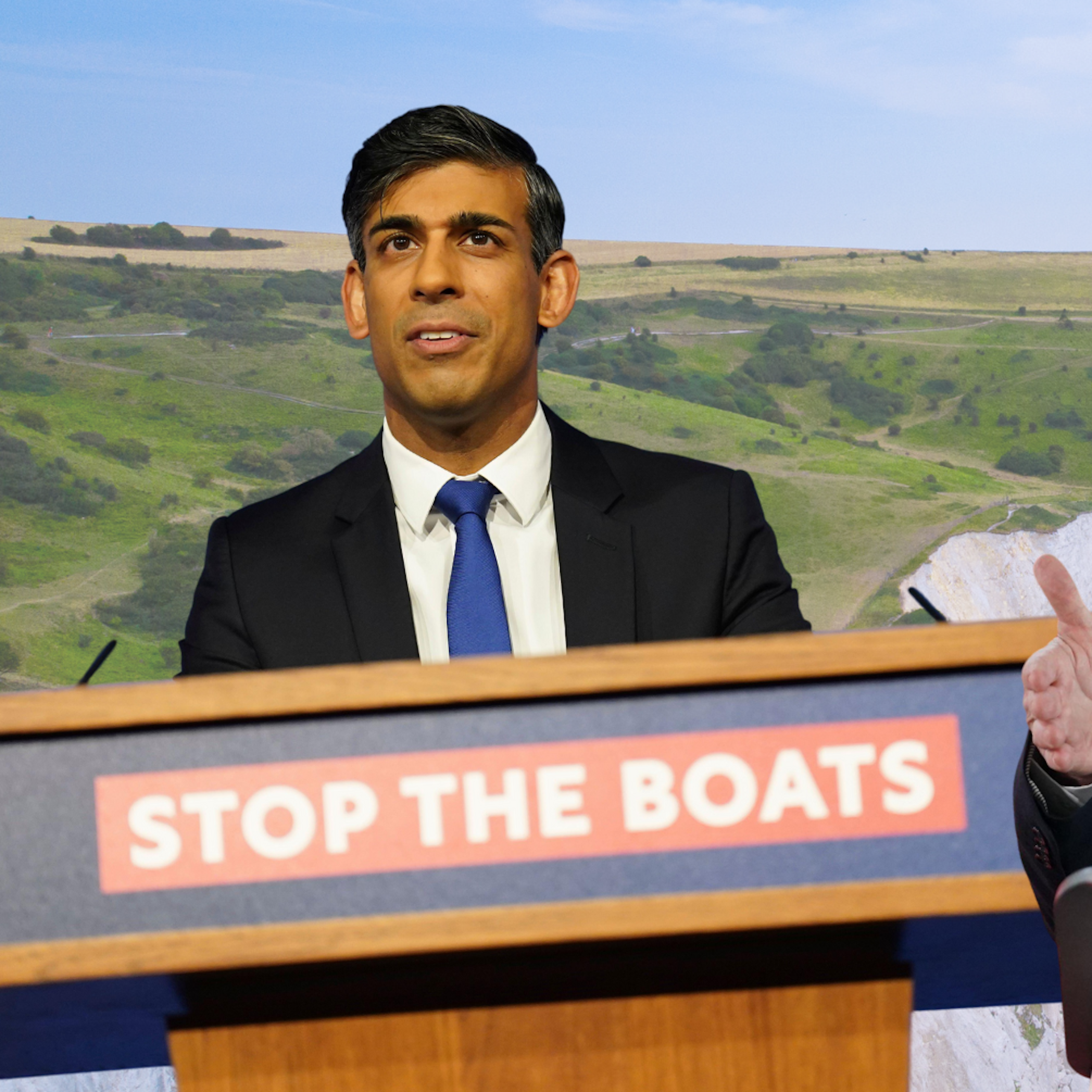 Photo collage of rishi sunak and keir starmer with their respective migration slogans in front of the white cliffs of dover