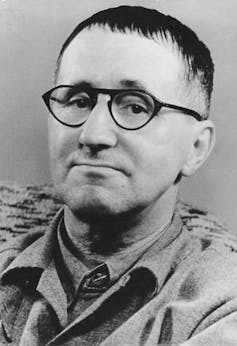 Black and white photo of Bertolt Brecht in glasses with short hair.