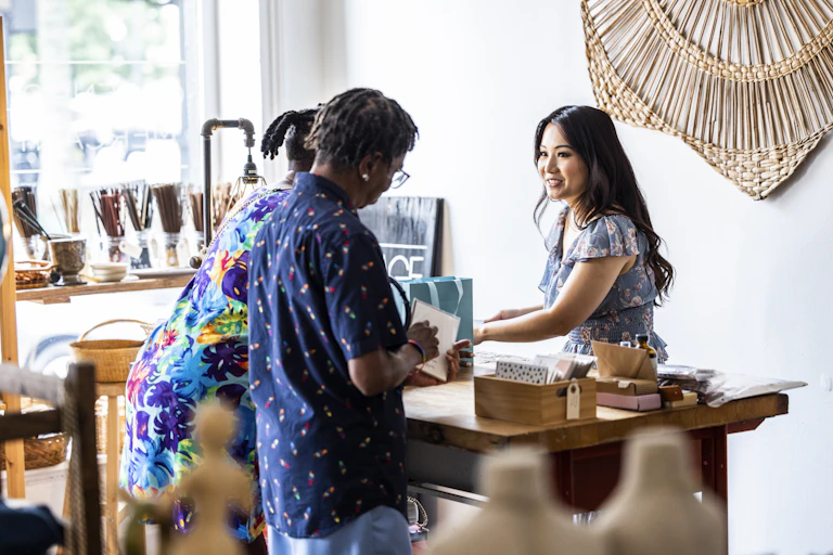 Two women are seen making a purchase at a female-owned small business.