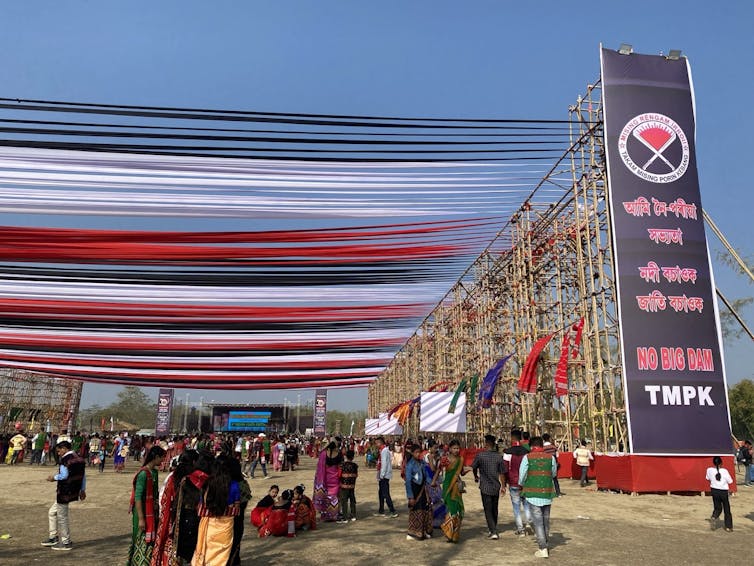 People walk under banners and streamers at a celebration