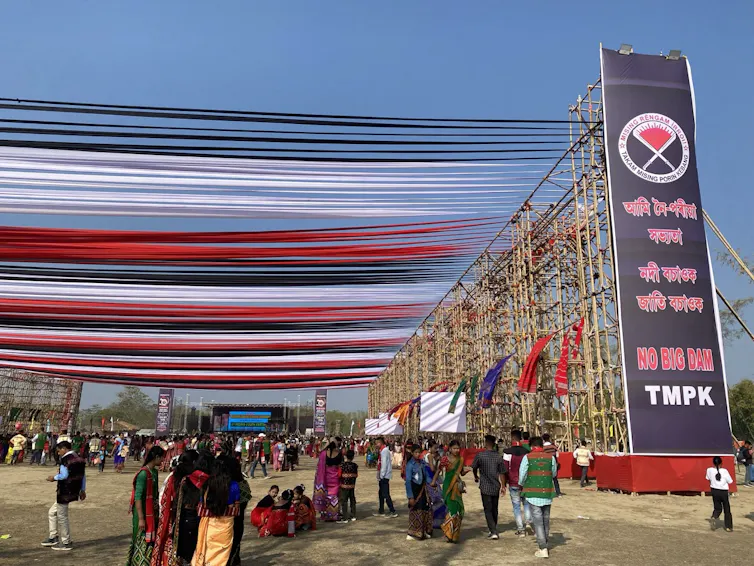 People walk under banners and streamers at a celebration