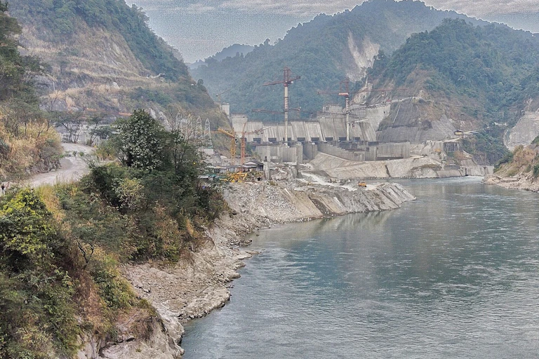 A photo of the dam in a rocky gorge with steep walls.