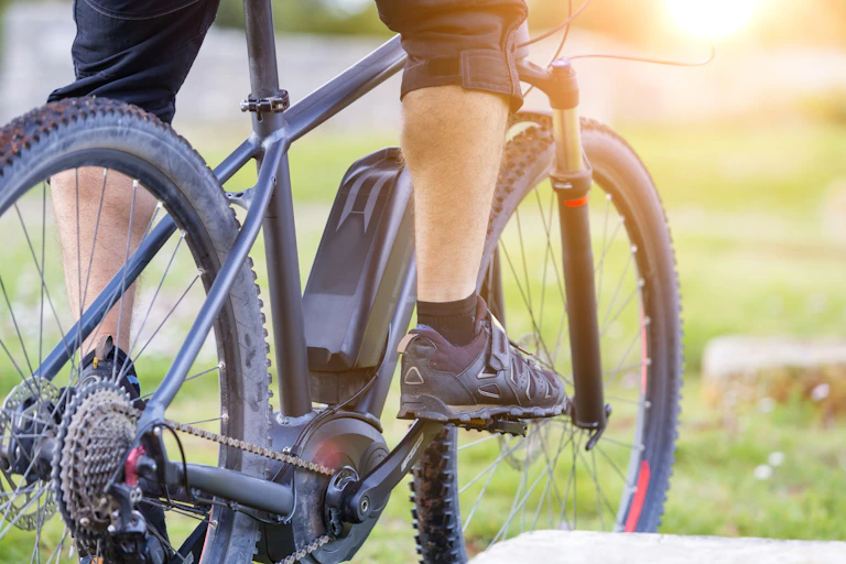 foot on pedal of e-bike