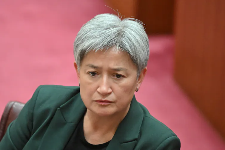 A grey haired woman in Parliament.