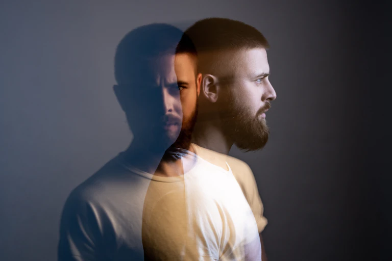 man's head in double exposure. looks in two directions