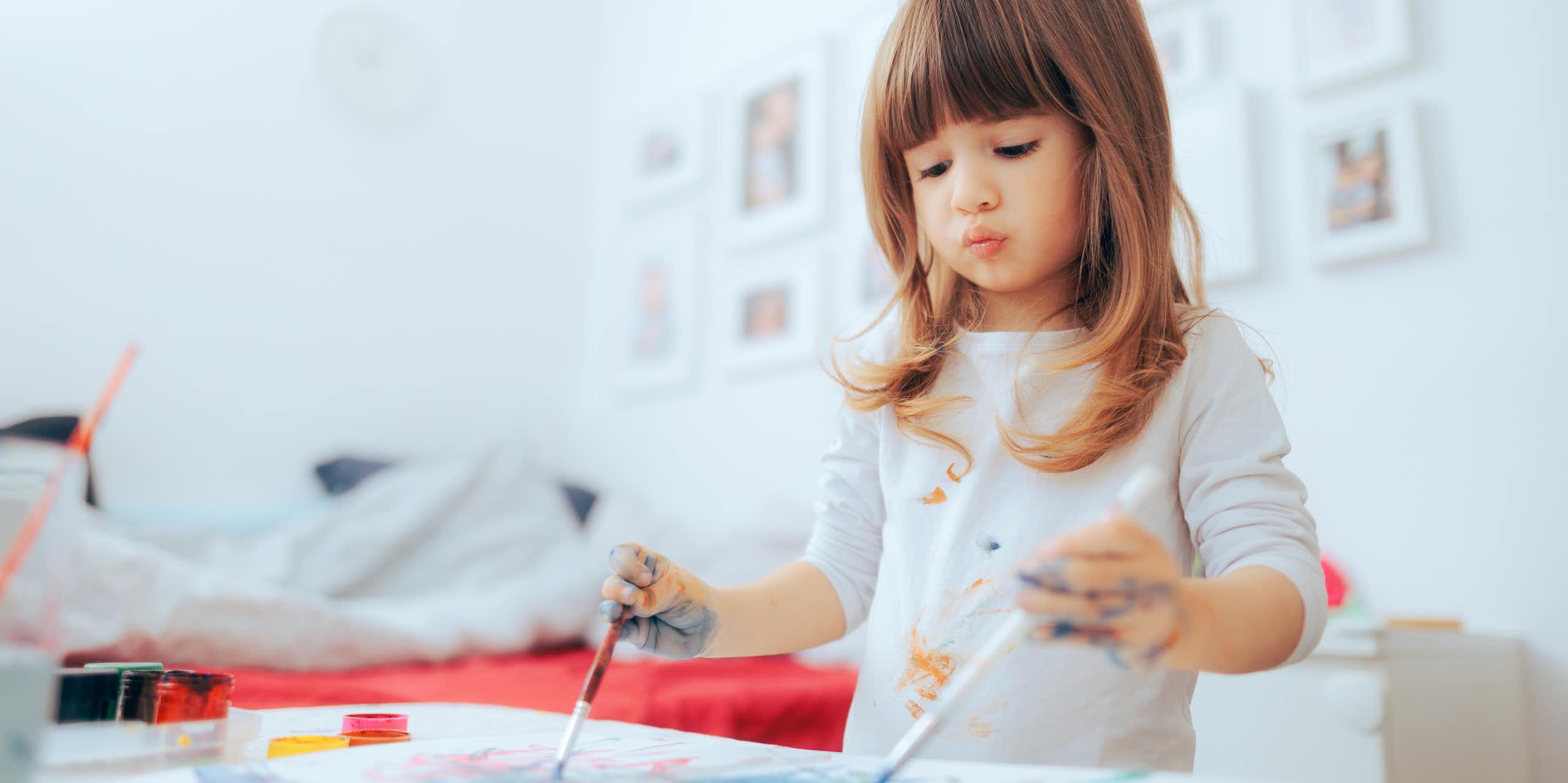 Girl painting with both hands
