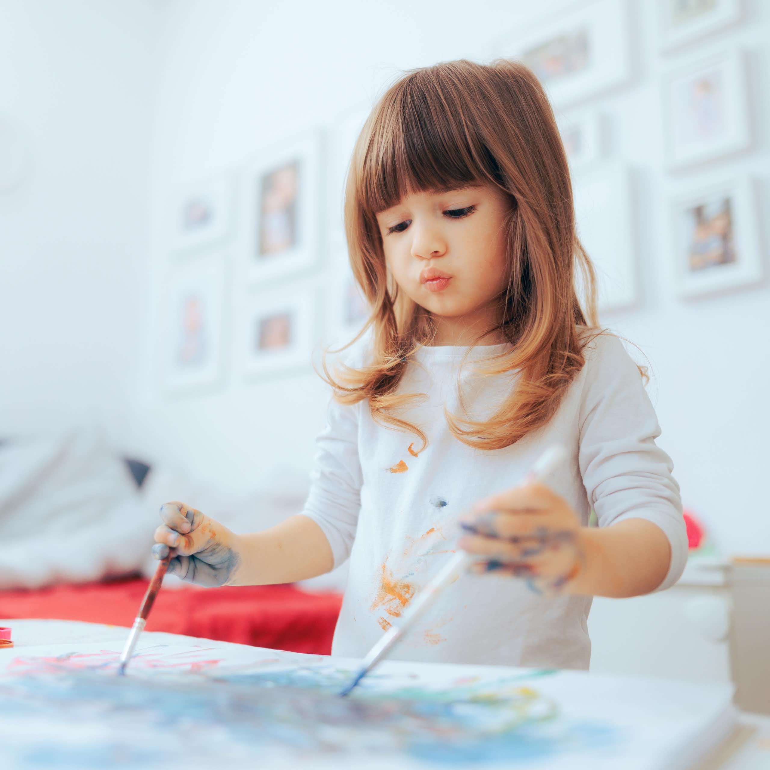 Girl painting with both hands