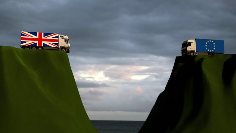 Digital illustration of two lorries, one with the design of a UK flag and the other with the design of an EU flag, facing each other on opposite cliff edges