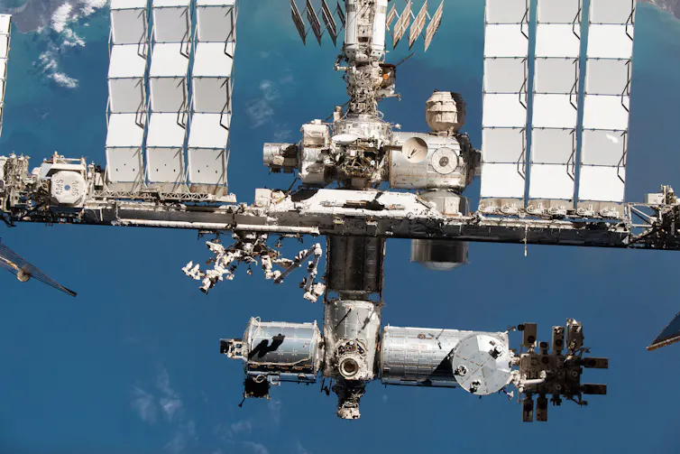 a structure with many interconnected parts in orbit over the Earth