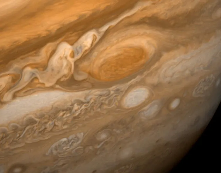 An image of Jupiter featuring brown, beige and orange belts along with the Great Red Spot.