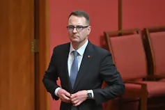 Man in suit standing in Senate chamber
