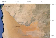 View of a desert landscapes with a river at the north end, and another former river that is marked by an interruption in dune patterns.