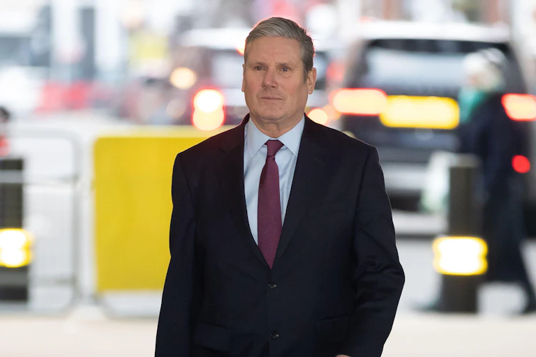 Man in dark suit looking pensive