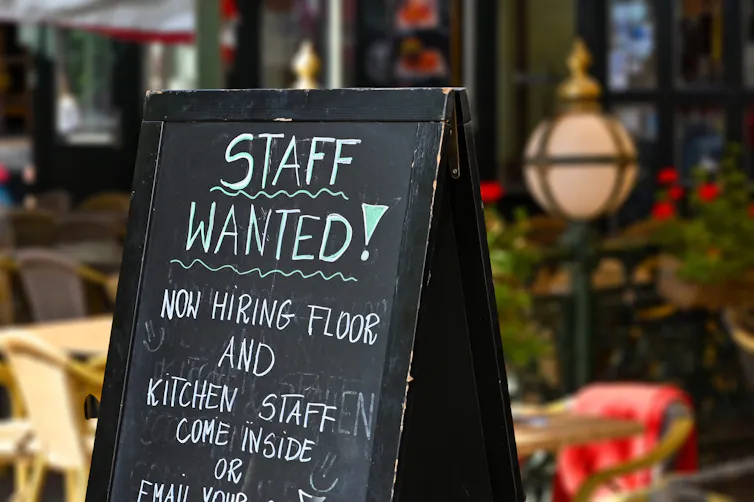 A chalkboard sign reads 'Staff wanted: Now hiring floor and kitchen staff'