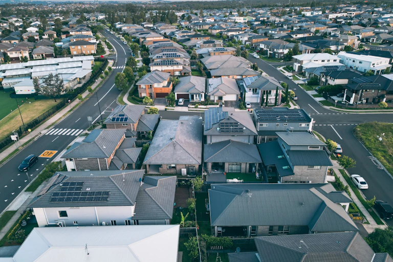An aerial view of a new suburb filled with houses with dark rooves