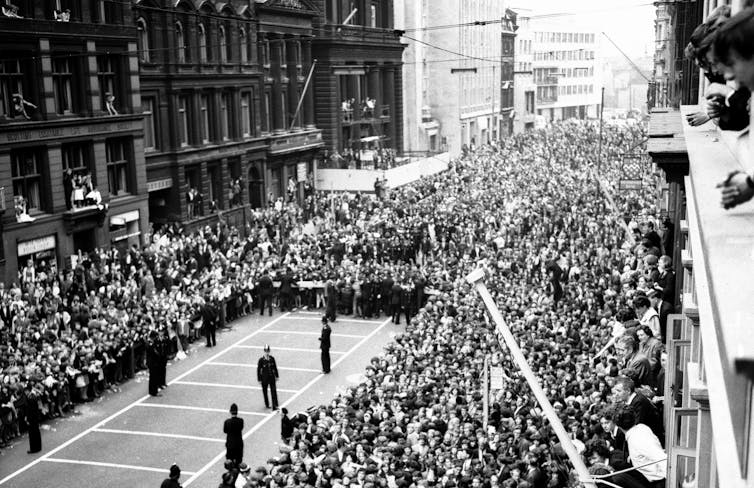 Police controlling a huge crowd in Liverpool street in 1964