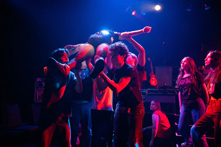 A woman crowd surfs.