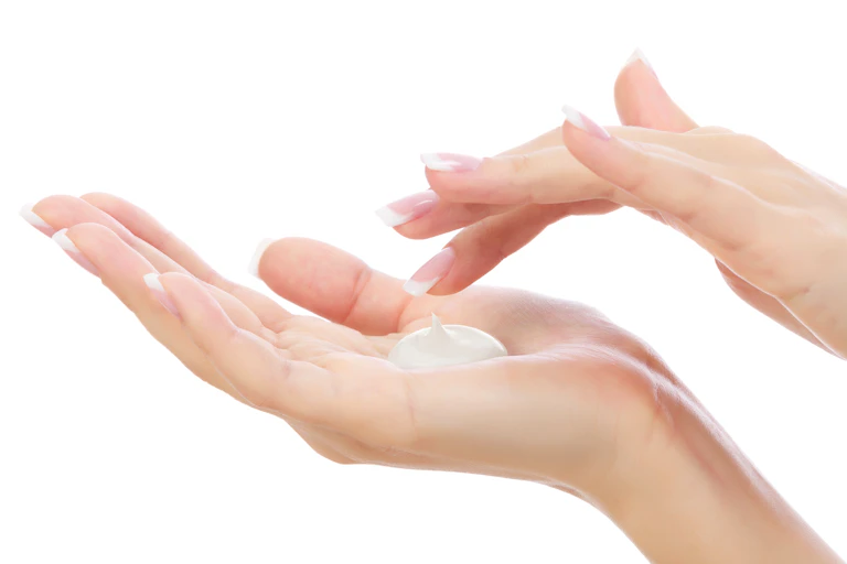 white background, women's hands with white cream on palm
