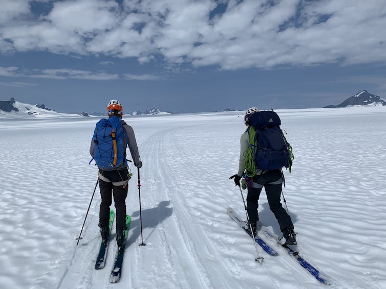 Two skiers on snowy glacier