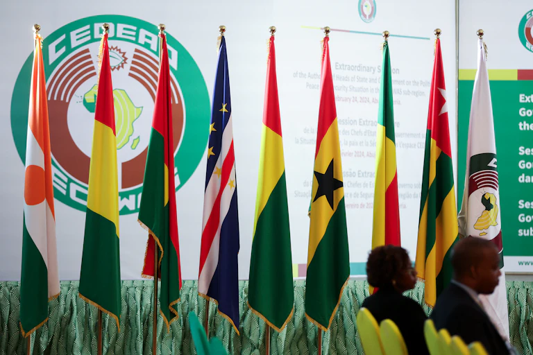Flags of different countries lined up in a room