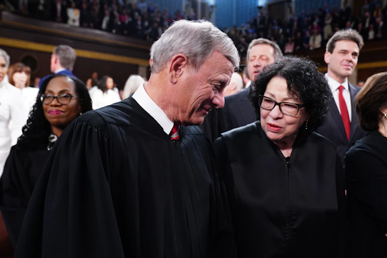 Chief Justice of the Supreme Court John Roberts (L) chats with Associate Justice Sonia Sotomayor (R) in the House of Representatives ahead of US President Joe Biden's third State of the Union address.