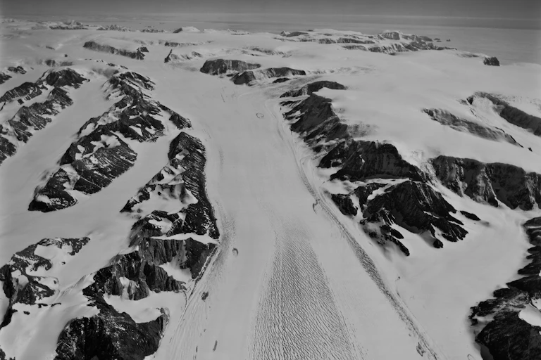 Black and white film photo of a glaciated mountain landscape.