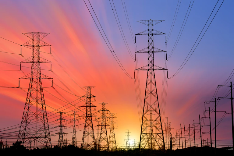 transmission towers at sunset