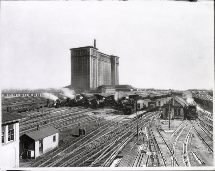 Historical black and white photo of the Michigan Central railroad with railyards in the foreground.