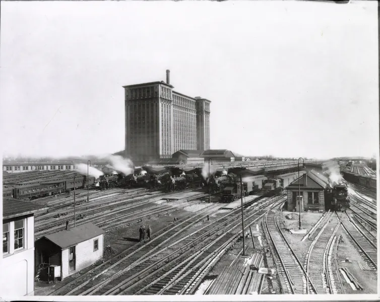 Historical black and white photo of the Michigan Central railroad with railyards in the foreground.