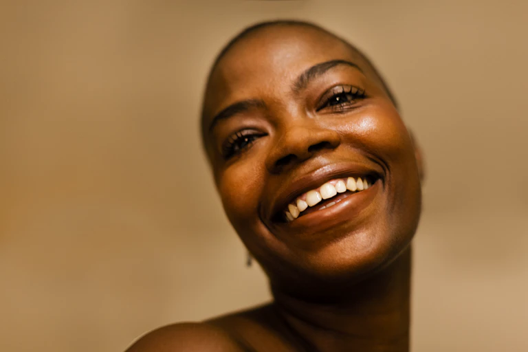 Black woman show from shoulders up with big smile
