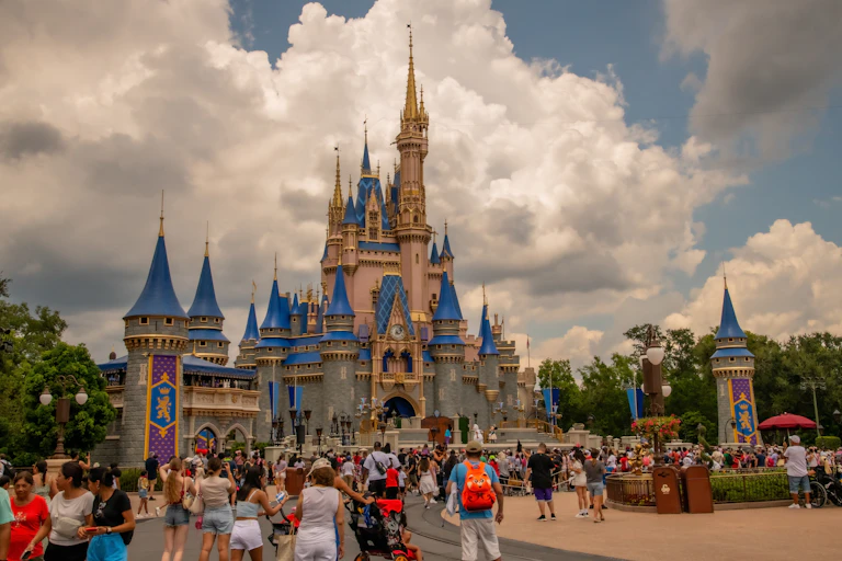 people walk near Cinderella's Castle at Disney world