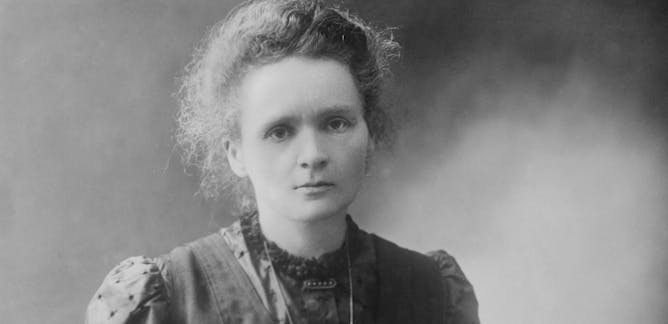 A portrait of Marie Curie or an image representing her laboratory setting. Keywords: Marie Curie, radioactivity, scientific research.