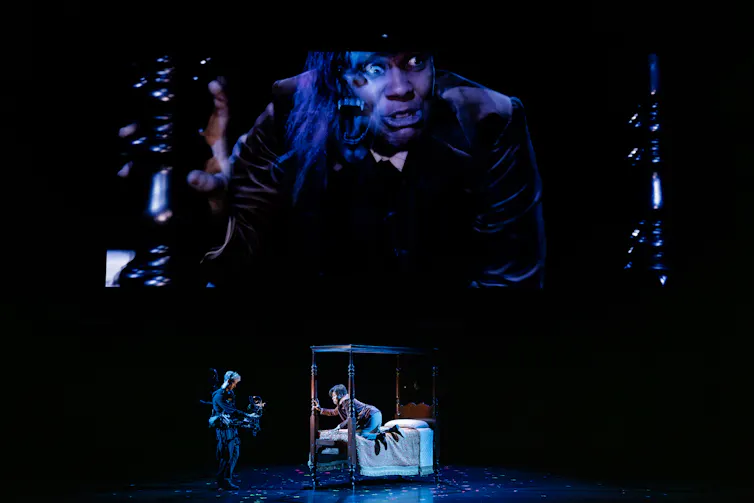 The staging: a big projection, an actor in bed.