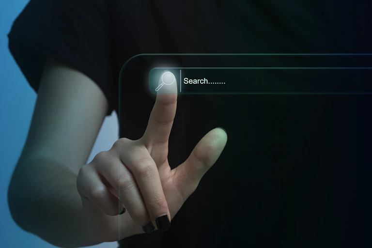 Finger touching search field on computer screen