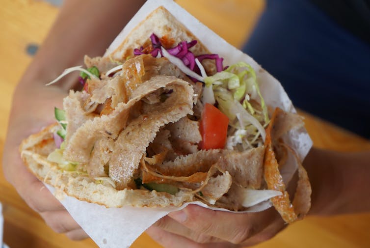 A doner kebab wrapped in paper