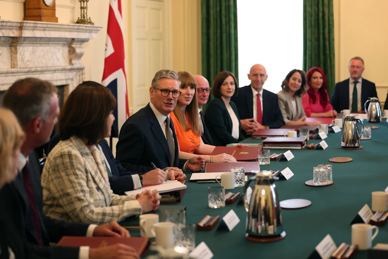 Keir Starmer and his cabinet sit at a long green table