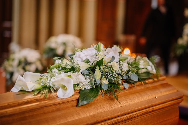 A casket with flowers on it