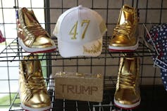 Gilded shoes and a ball cap emblazoned with a golden 47 sit on a display shelf.