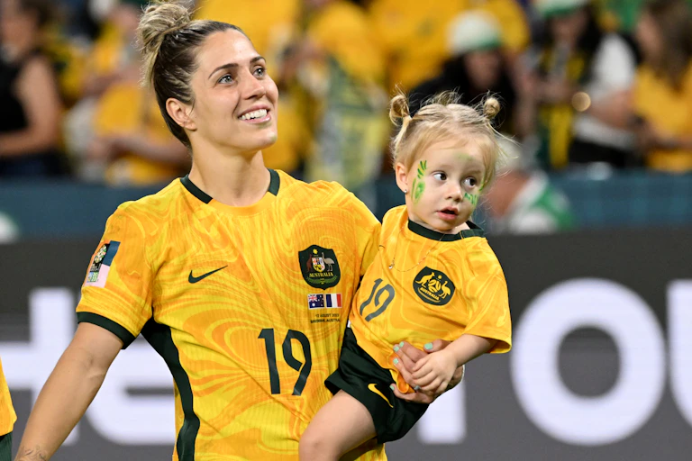 Katrina Gorry of Australia celebrates wither with her baby after a World Cup game