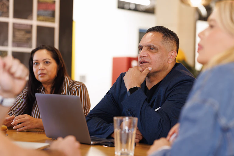 Aboriginal people sit around a table