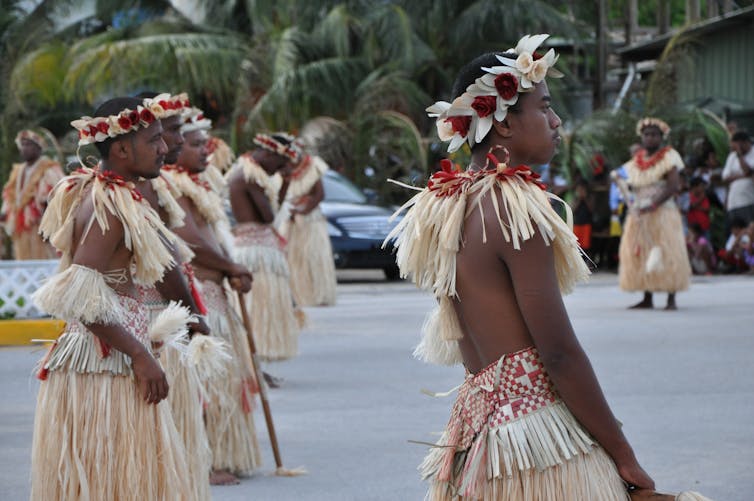 Men dancing in traditional outfits