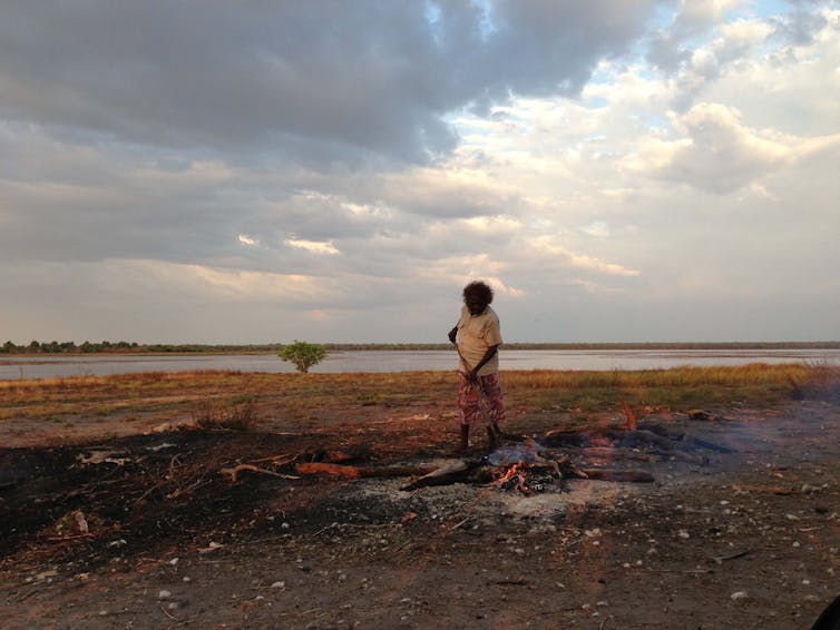 woman stokes fire