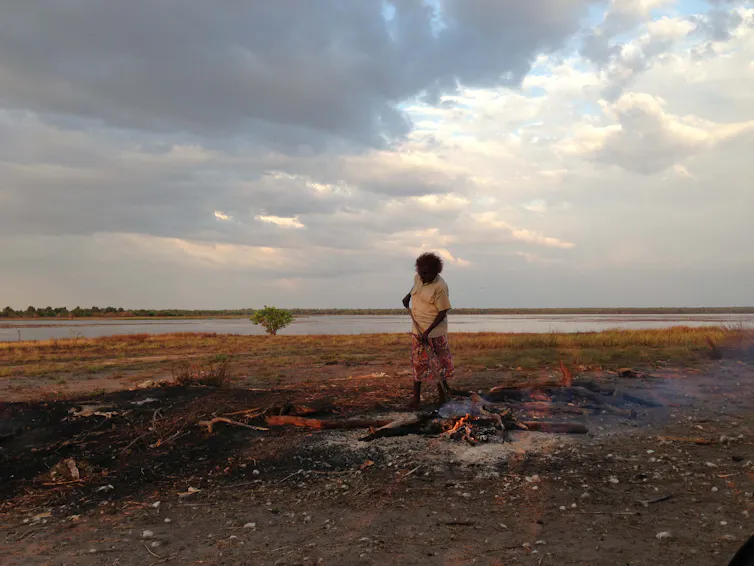 woman stokes fire