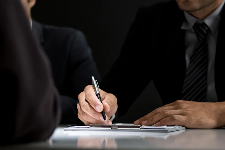 Closeup businessman's hands signing document