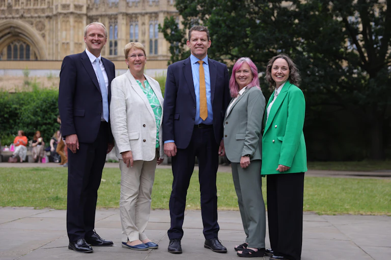 Four of Plaid Cymru's newly elected MPs stand outside the Houses of Parliament with the party leader, Rhun ap Iorwerth