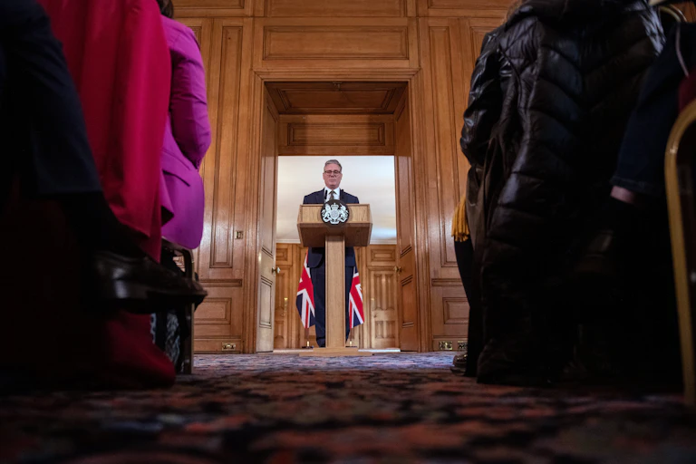 Keir Starmer giving a speech at a lectern.
