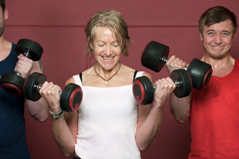 An older woman performs a bicep curl.