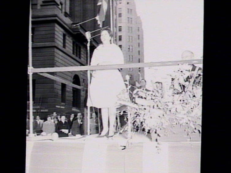 A woman sings on stage.