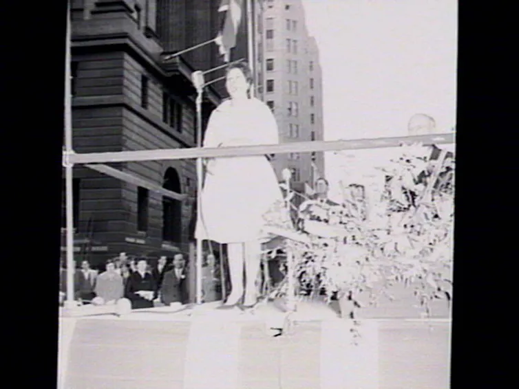 A woman sings on stage.